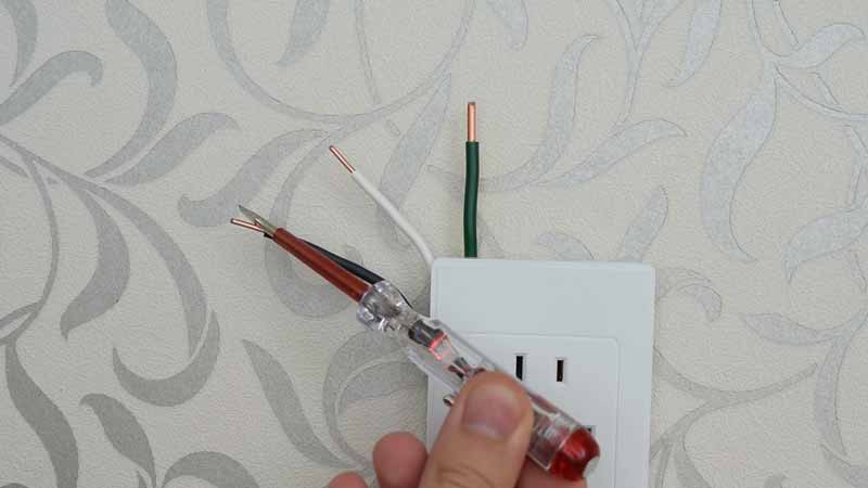 A live wire testing with neon screwdriver