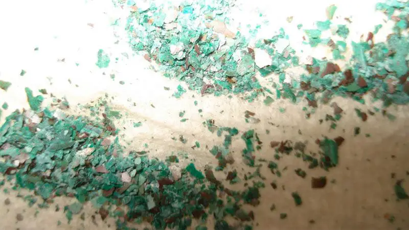 Blue/Green Flakes in Water