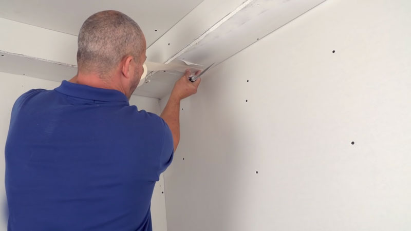 man installing drywall