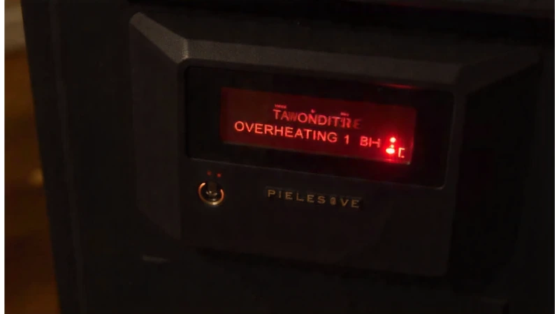 A pellet stove's digital control panel displaying a high temperature warning for pellet stove overheating.