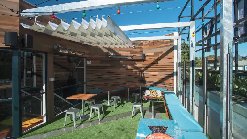 stylish outdoor commercial space with a white retractable shade sail