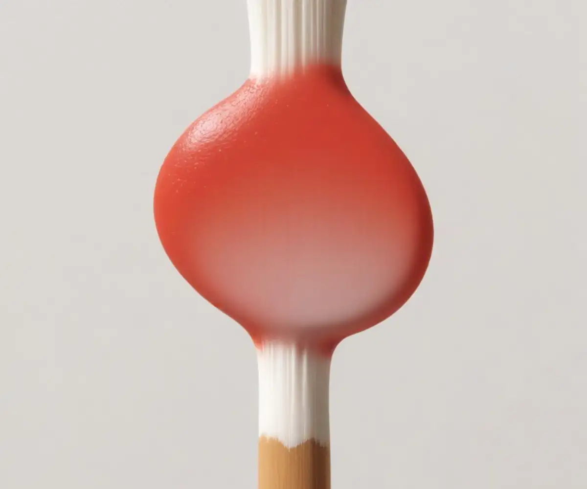 Close-up of a lead test swab showing a red color change on a white painted surface.