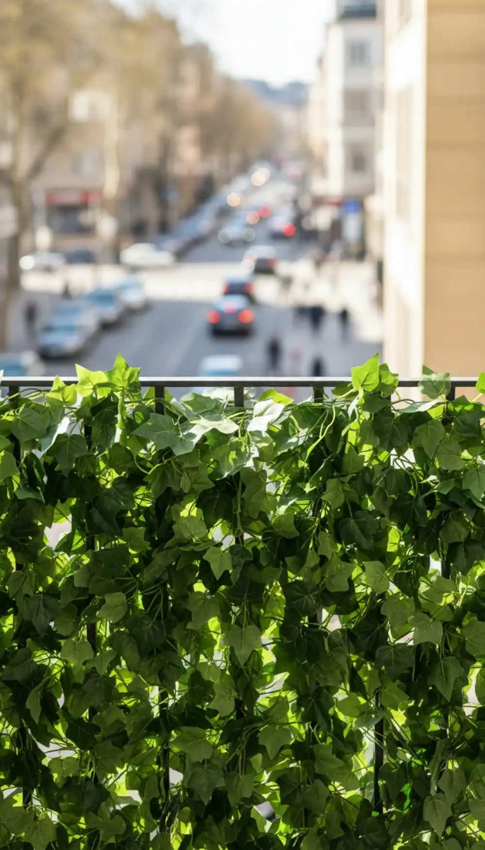 Balcony railing wrapped in realistic green faux ivy garland