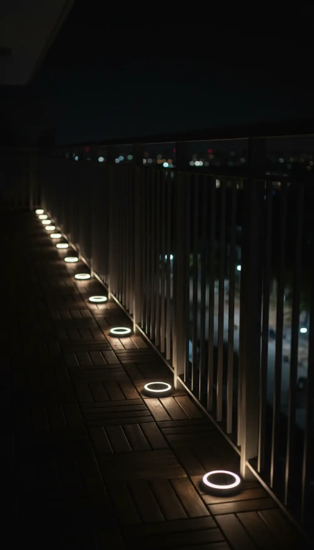 Small solar lights illuminating the edges of a balcony floor