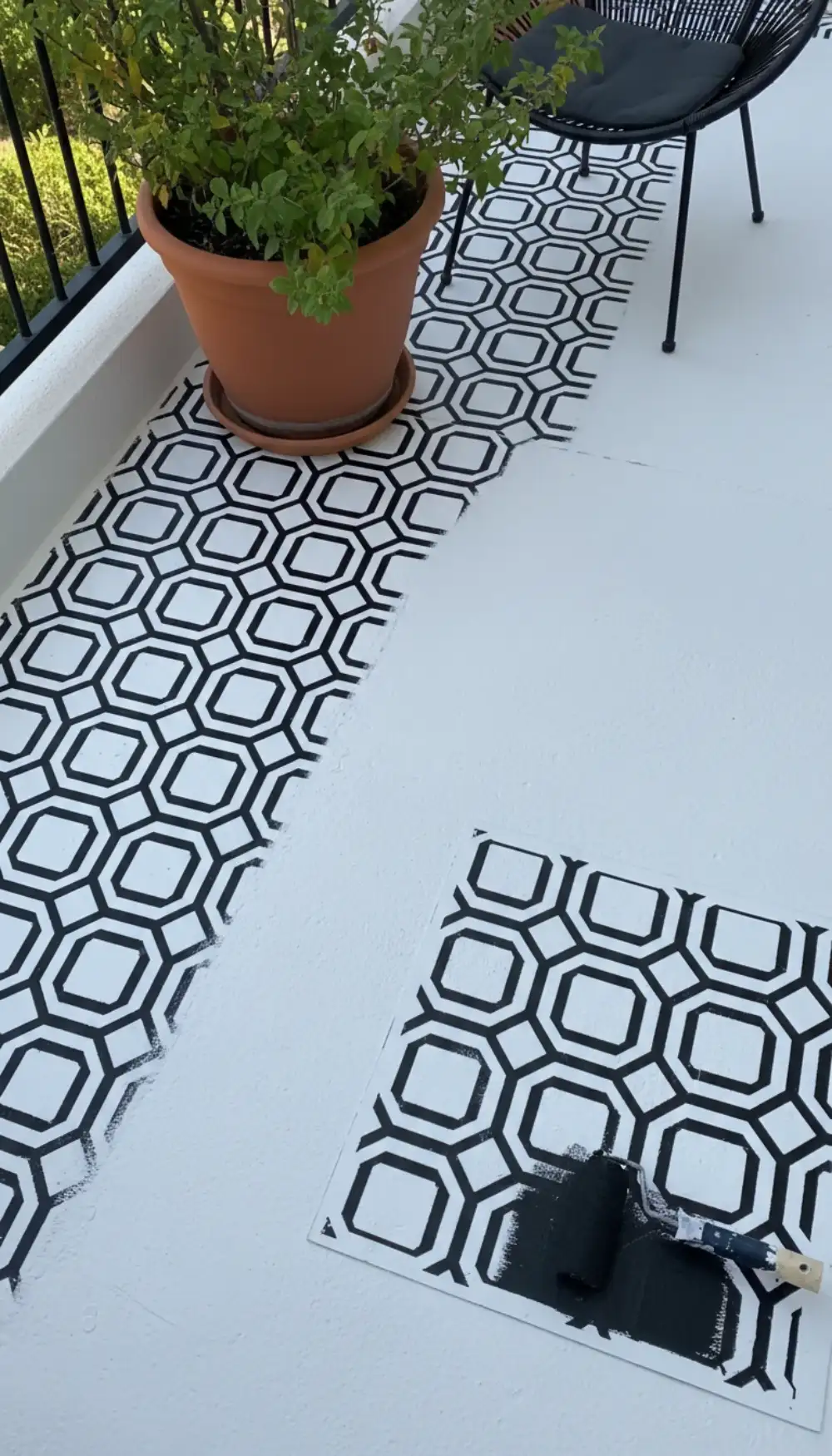 Concrete balcony floor painted with a black and white stencil pattern