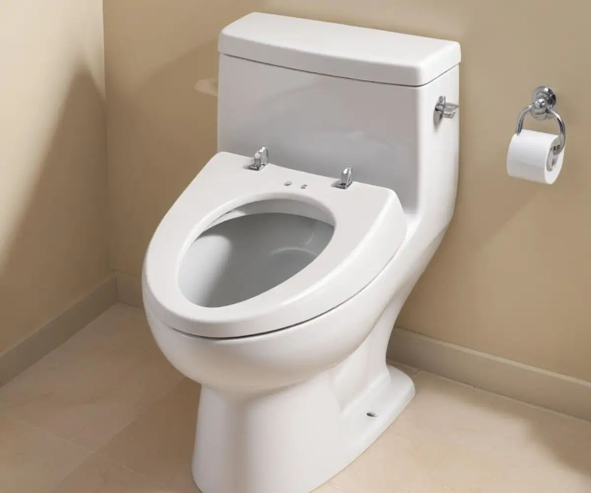 A white bidet toilet seat that is too large for a round toilet bowl, showing significant overhang at the front.