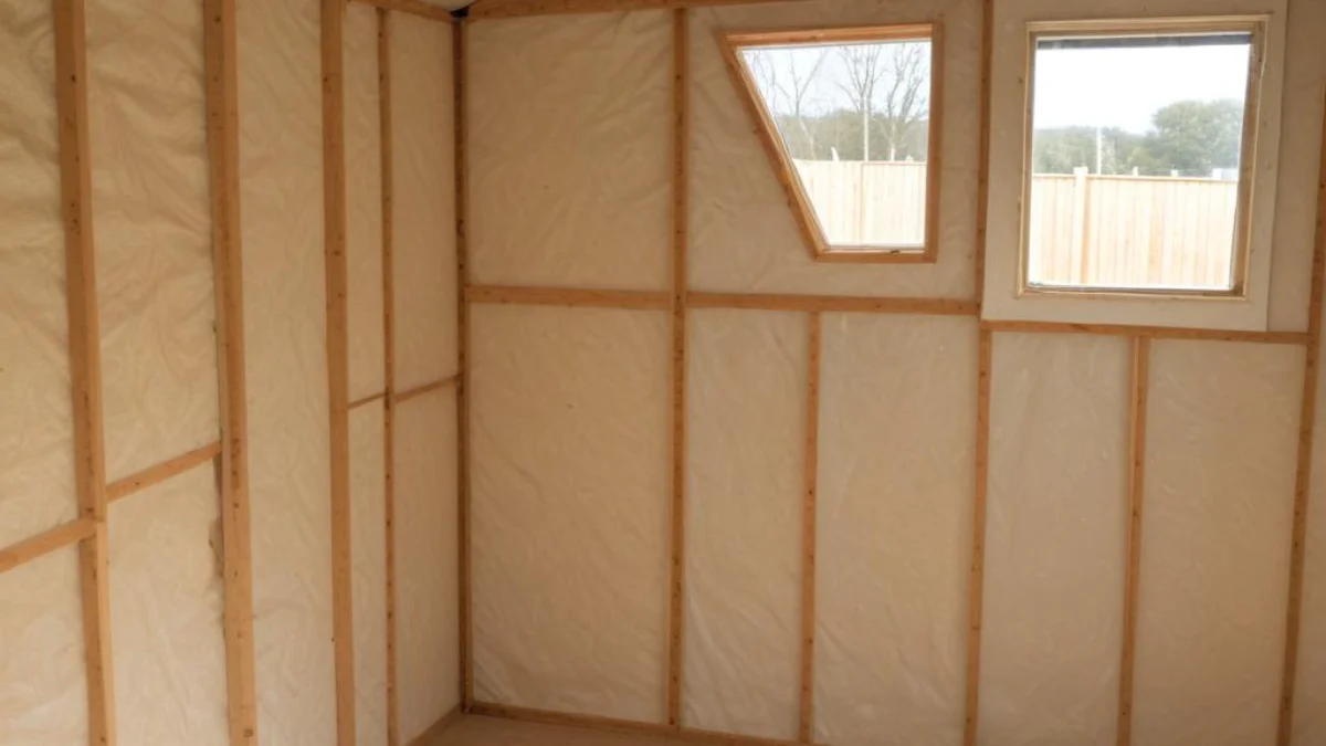 Interior of a plastic shed with rigid foam insulation panels fitted to the walls.