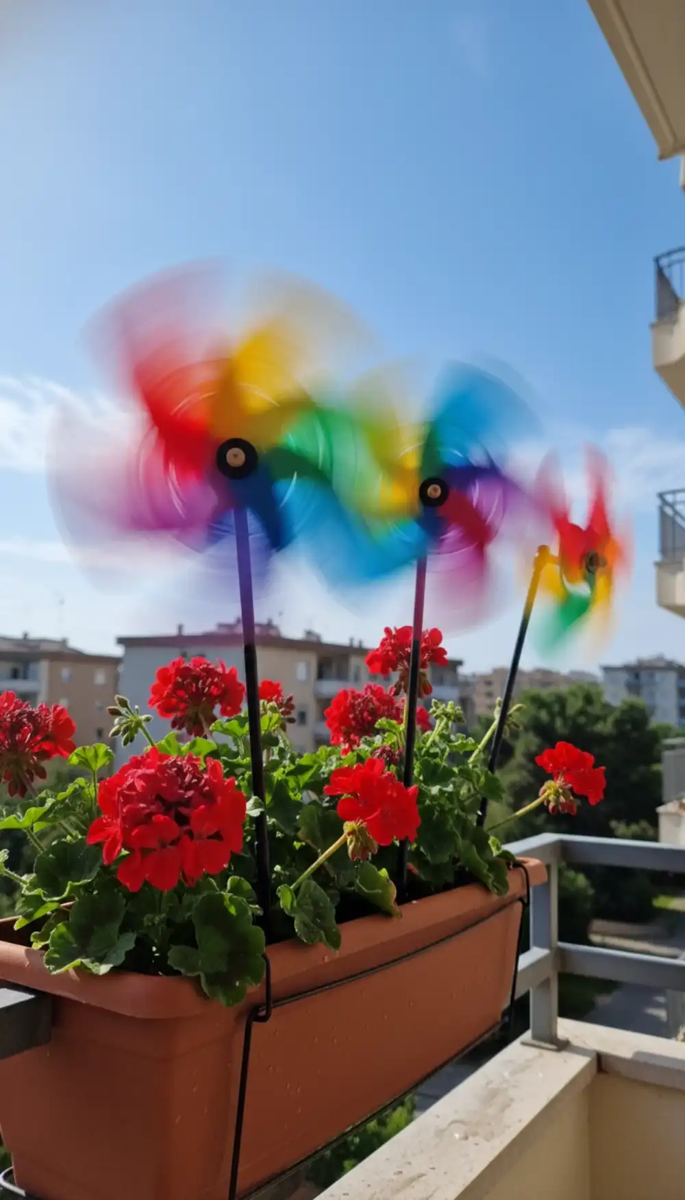 Spinning colorful plastic pinwheels stuck in flower pots