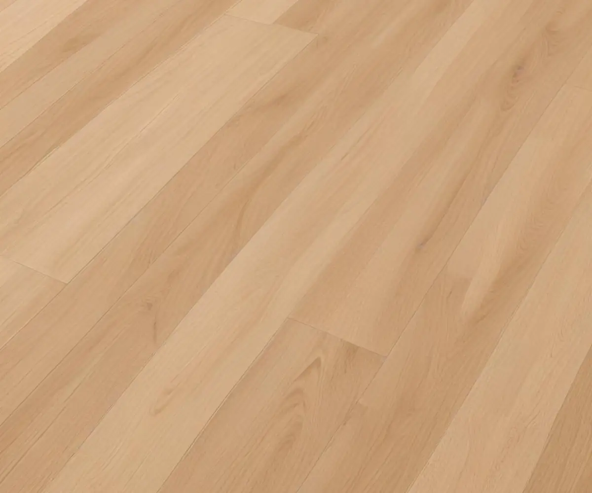 A detailed close-up of light oak colored luxury vinyl plank flooring laid in a herringbone pattern on a clean, modern floor.