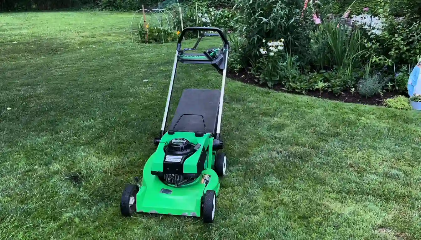 A green and white Lawn-Boy M-Series push mower with a cast magnesium deck resting on a healthy green lawn.