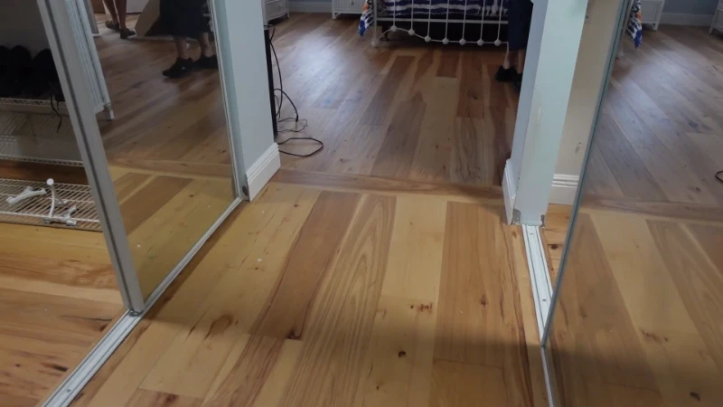 An intricate, circular wood inlay medallion set in the center of a polished hardwood floor.