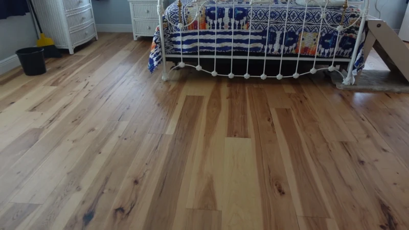 An intricate, circular wood inlay medallion set in the center of a polished hardwood floor.