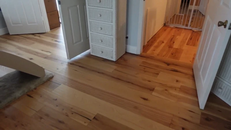 An intricate, circular wood inlay medallion set in the center of a polished hardwood floor.