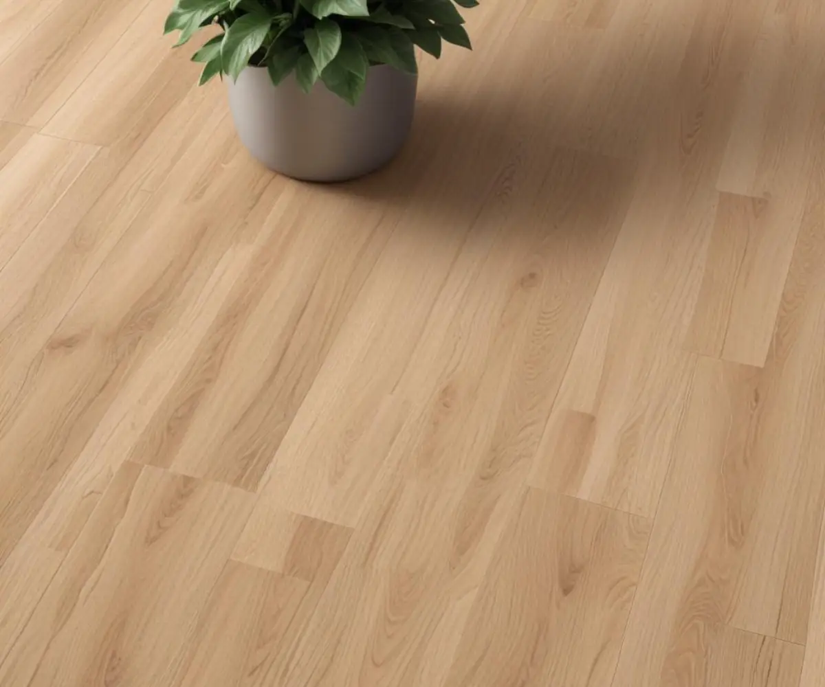 A close-up view of interlocking luxury vinyl plank flooring showcasing a realistic, textured wood grain pattern in a neutral oak color.