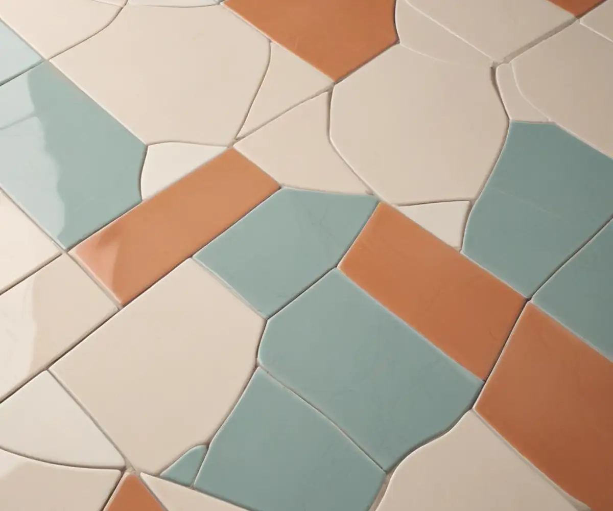 A close-up view of two different styles of interlocking porcelain floor tiles on a neutral background.