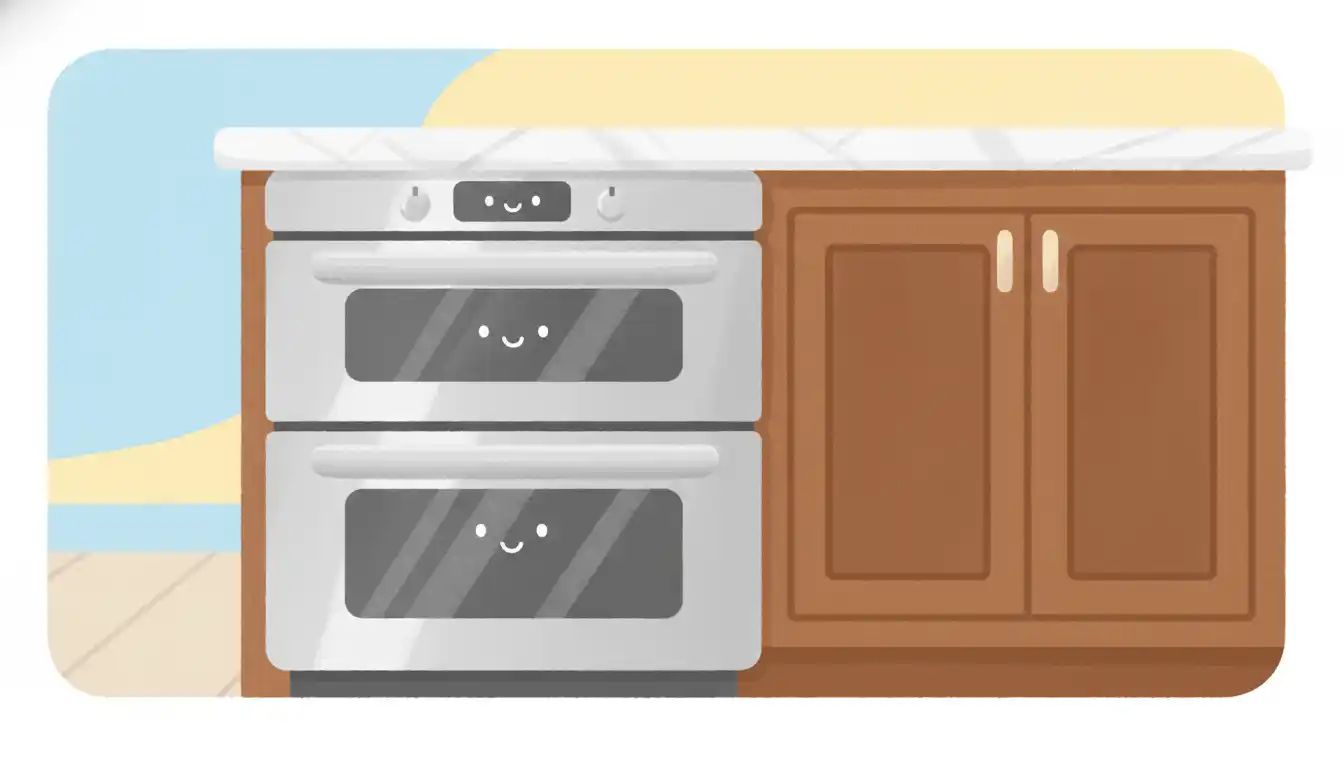 A stainless steel, side-by-side double oven built-in under a white marble kitchen countertop, next to dark wood cabinetry.