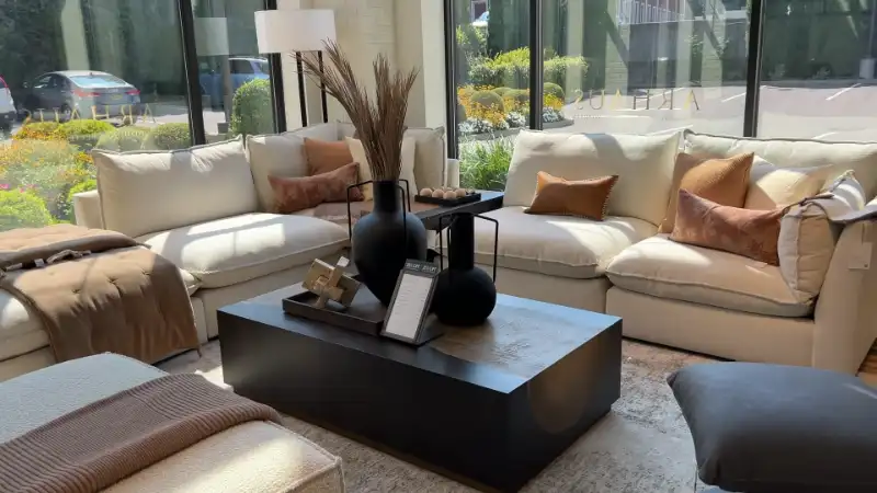 A close-up view of the detailed wood grain and joinery on a high-end, solid wood sideboard.