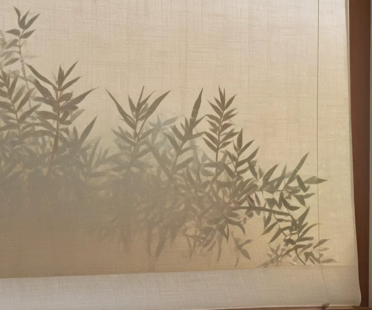 A close-up of a textured, light-filtering roller shade on a clean, modern window frame.